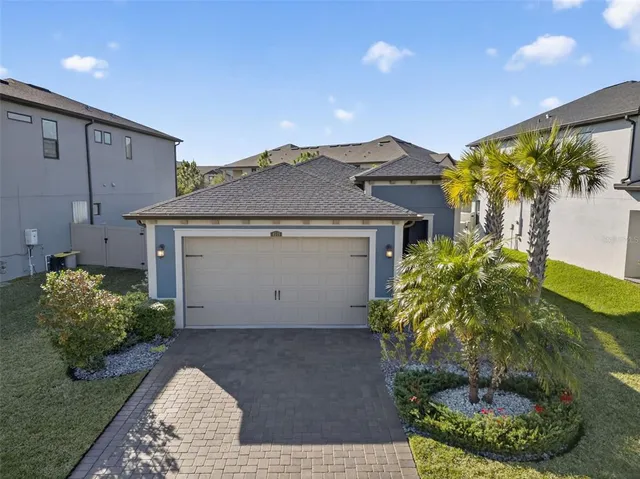 an aerial view of a house with a yard