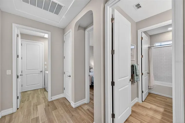 a bedroom with a bed and wooden floor