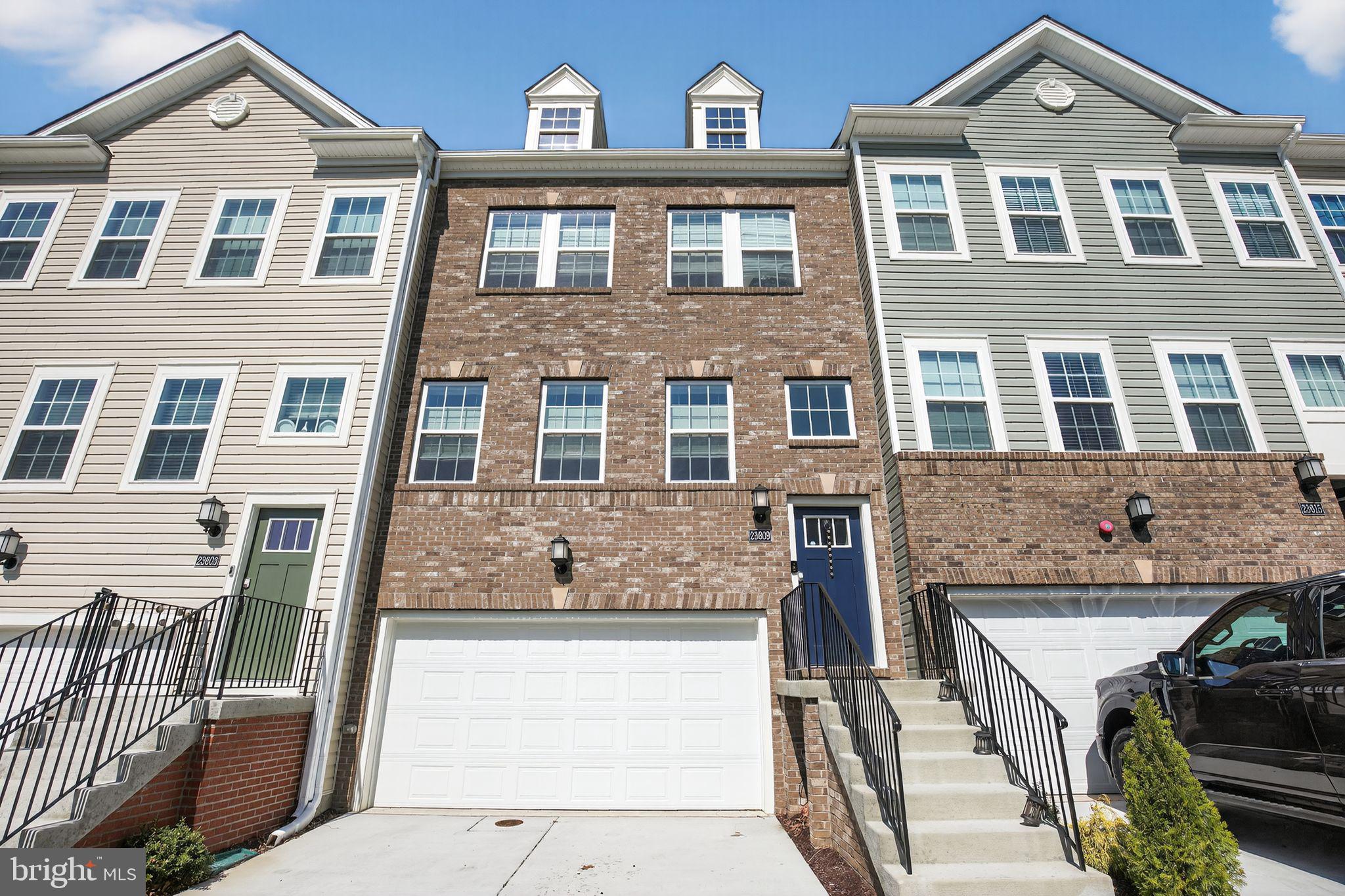 23609 Crosswinds Way California, MD 20619 - Photo 2 of 29 a front view of a residential apartment building with a yard