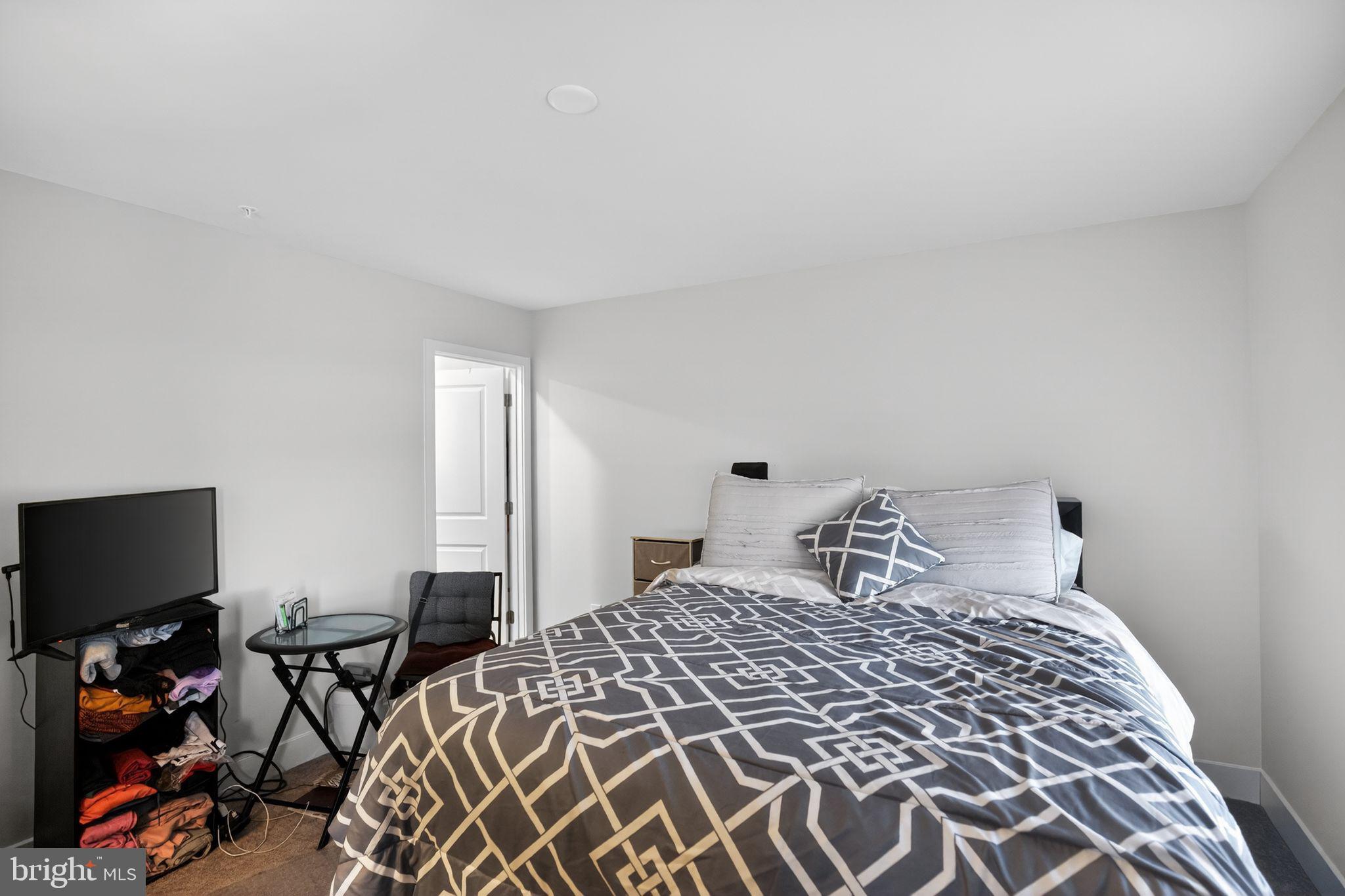23609 Crosswinds Way California, MD 20619 - Photo 23 of 29 a bedroom with a bed and a flat screen tv