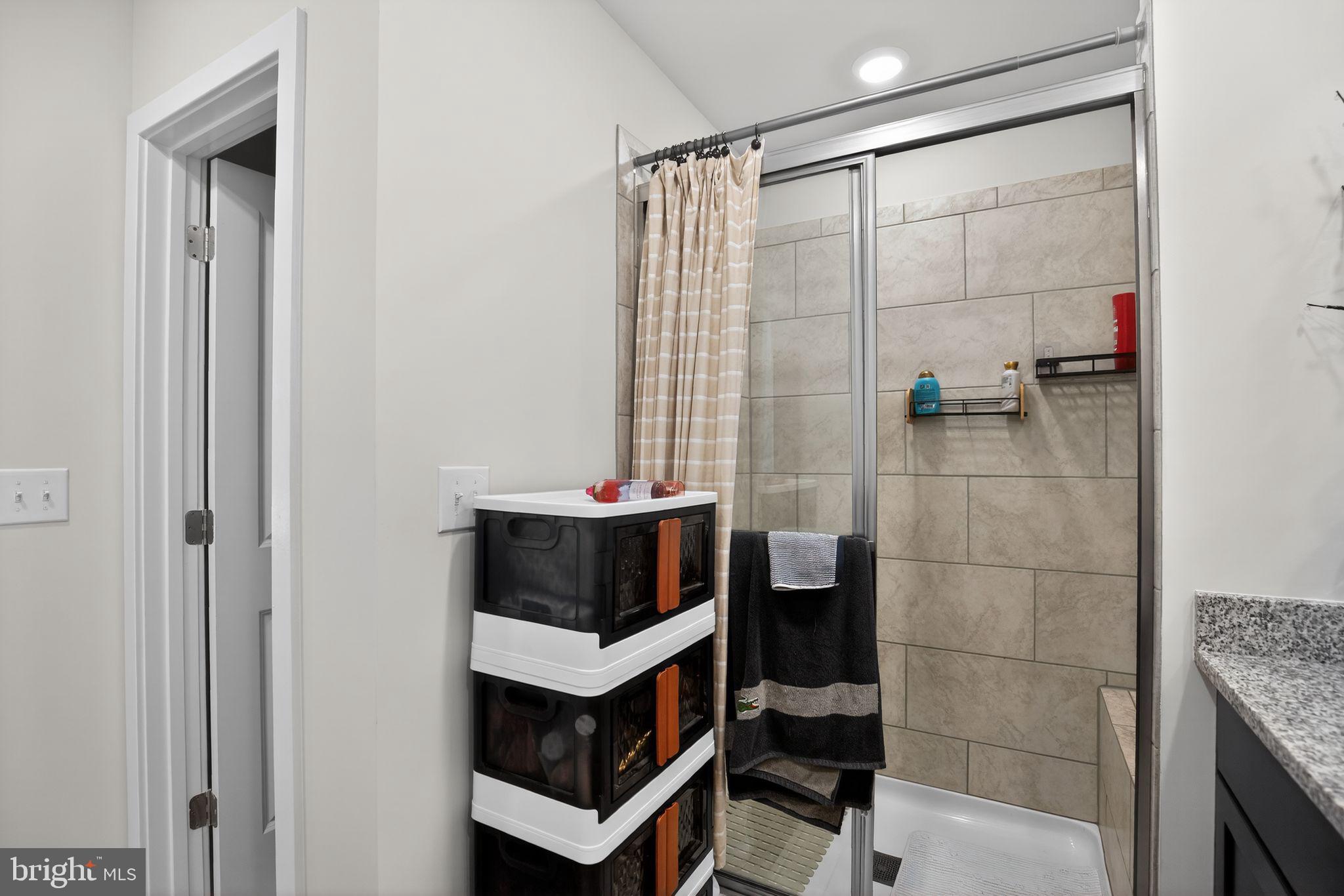 23609 Crosswinds Way California, MD 20619 - Photo 24 of 29 a bathroom with a shower and a sink