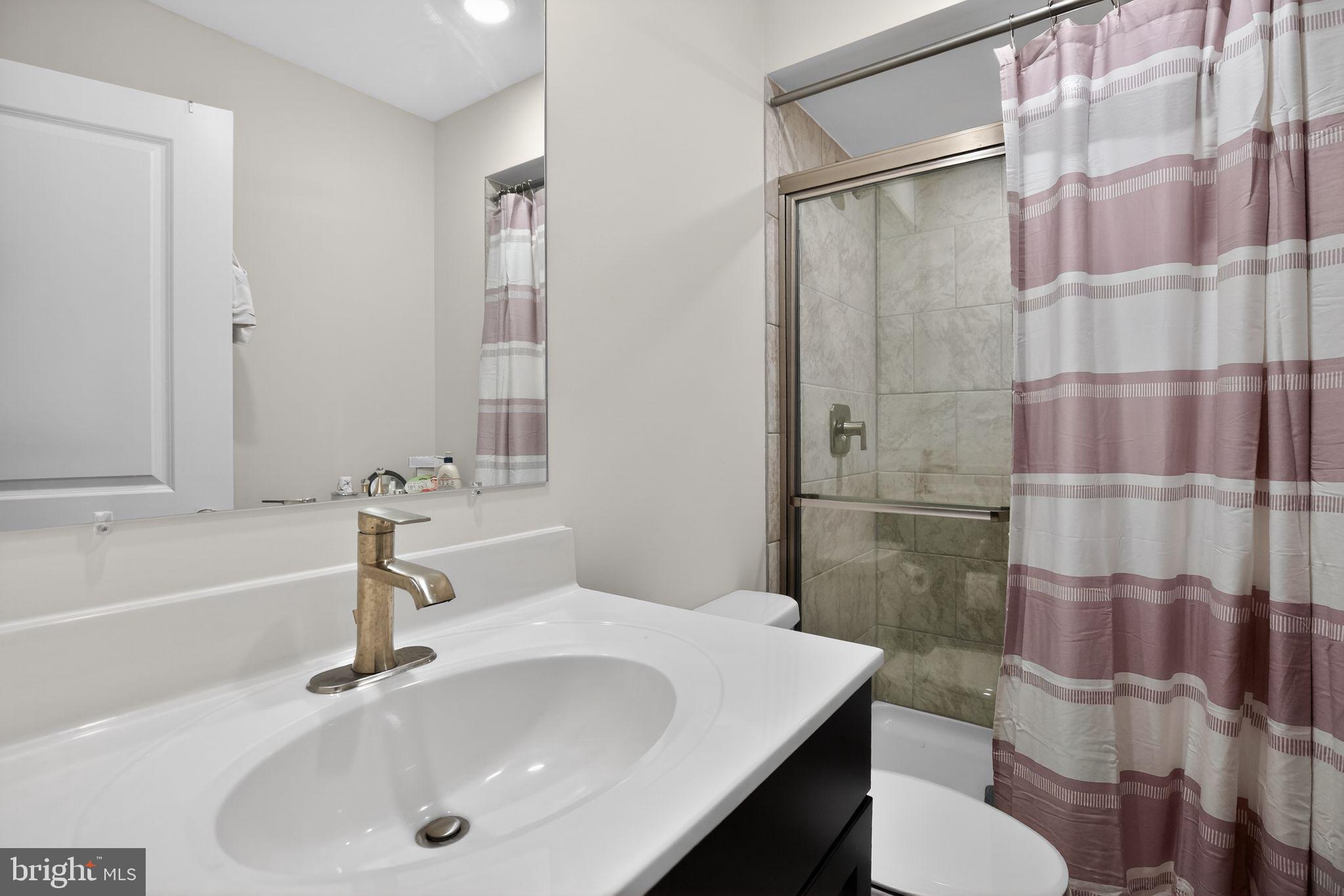 23609 Crosswinds Way California, MD 20619 - Photo 25 of 29 a bathroom with a sink and a mirror