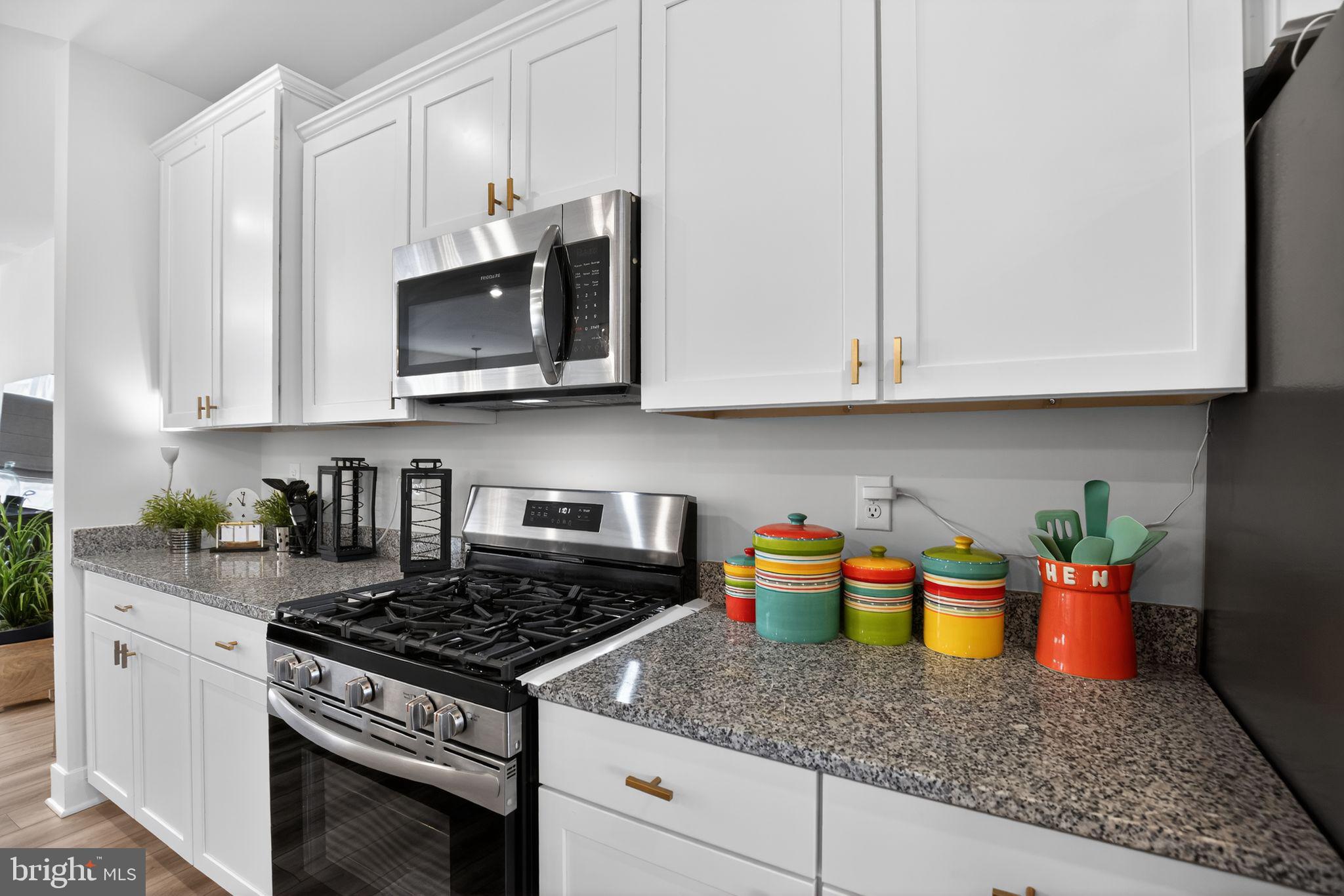 23609 Crosswinds Way California, MD 20619 - Photo 5 of 29 a kitchen with stainless steel appliances granite countertop a sink stove and cabinets