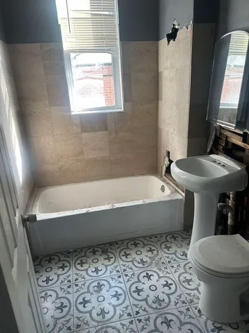 a bathroom with a bathtub and a toilet