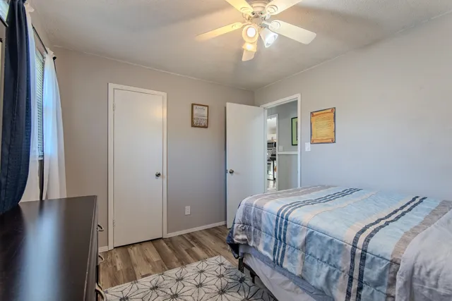 a bedroom with a bed and wooden floor