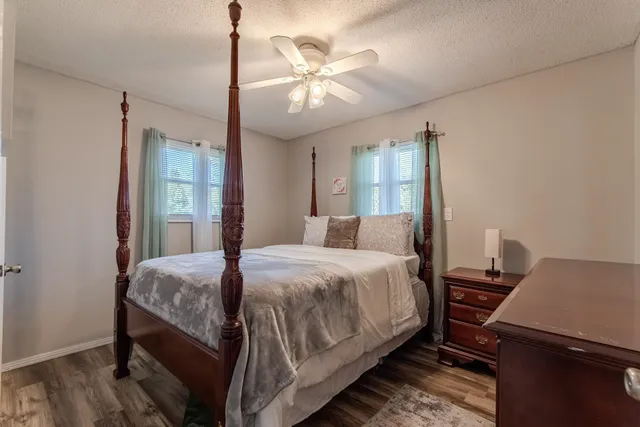 a bedroom with a bed and a chandelier