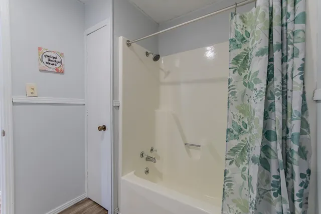 a bathroom with a bathtub and shower