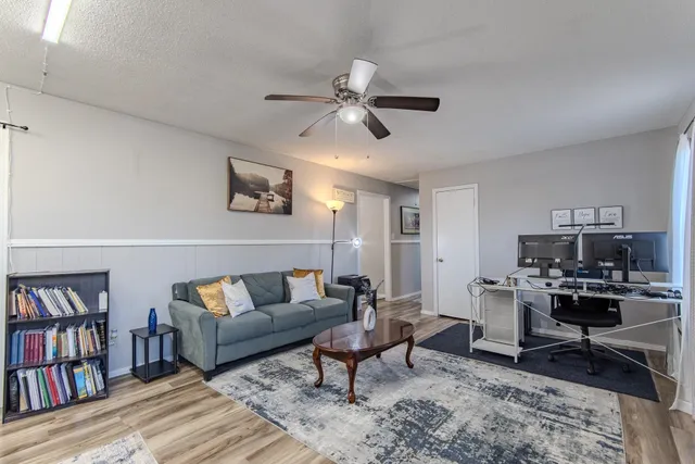 a living room with furniture and a book shelf