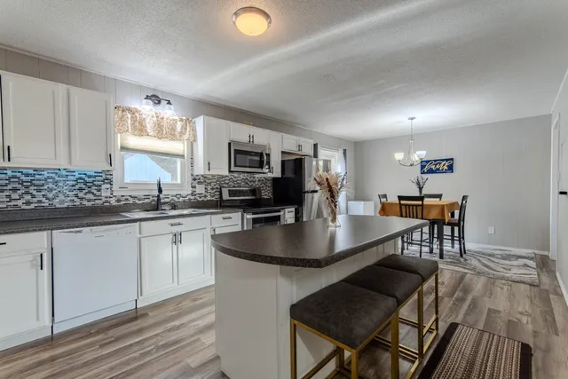 a kitchen with sink cabinets and dining table