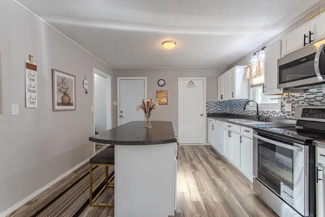 a kitchen with stainless steel appliances granite countertop a stove and a sink