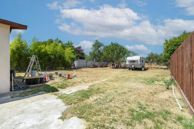 a swimming pool with outdoor seating and yard