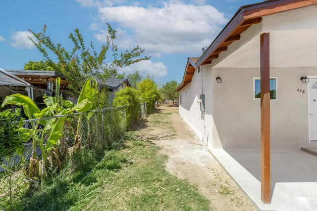 an aerial view of a house with garden space and street view