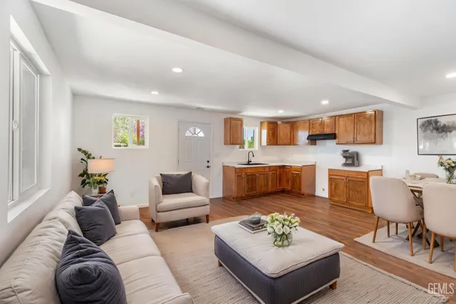 a living room with furniture kitchen view and a table