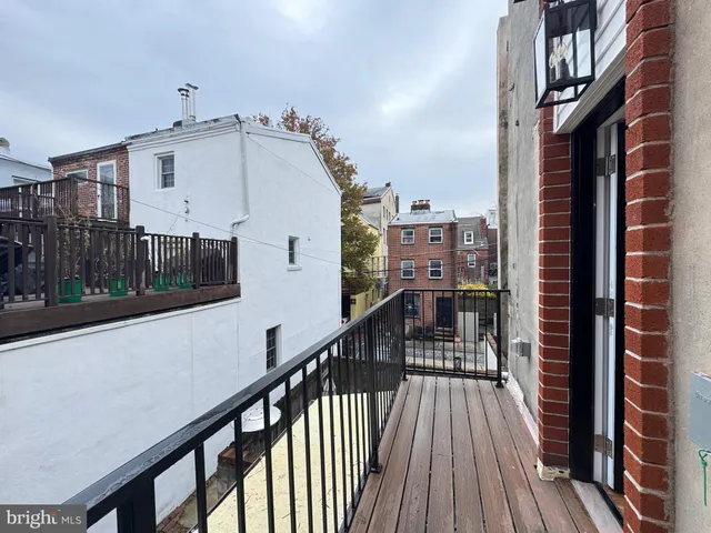 a view of a balcony with wooden floor and stairs