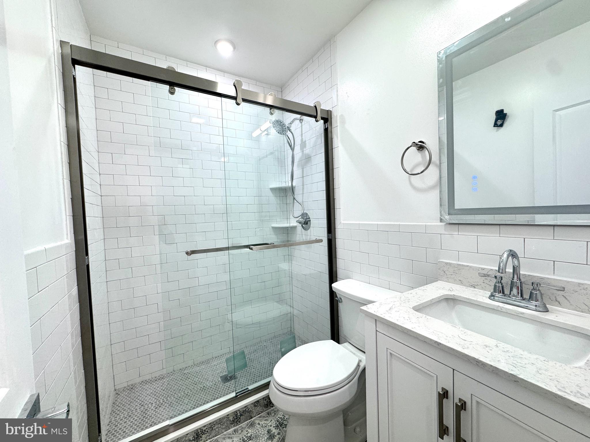 781 South 3rd Street, Unit 2 Philadelphia, PA 19147 - Photo 17 of 17 a bathroom with a granite countertop sink toilet and shower
