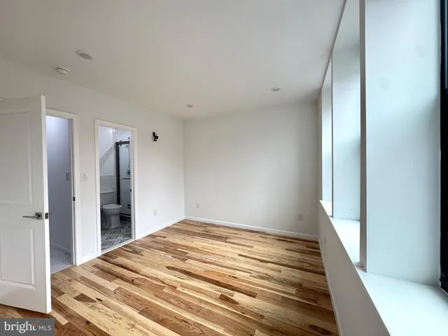 a bedroom with a bed and a walk in closet