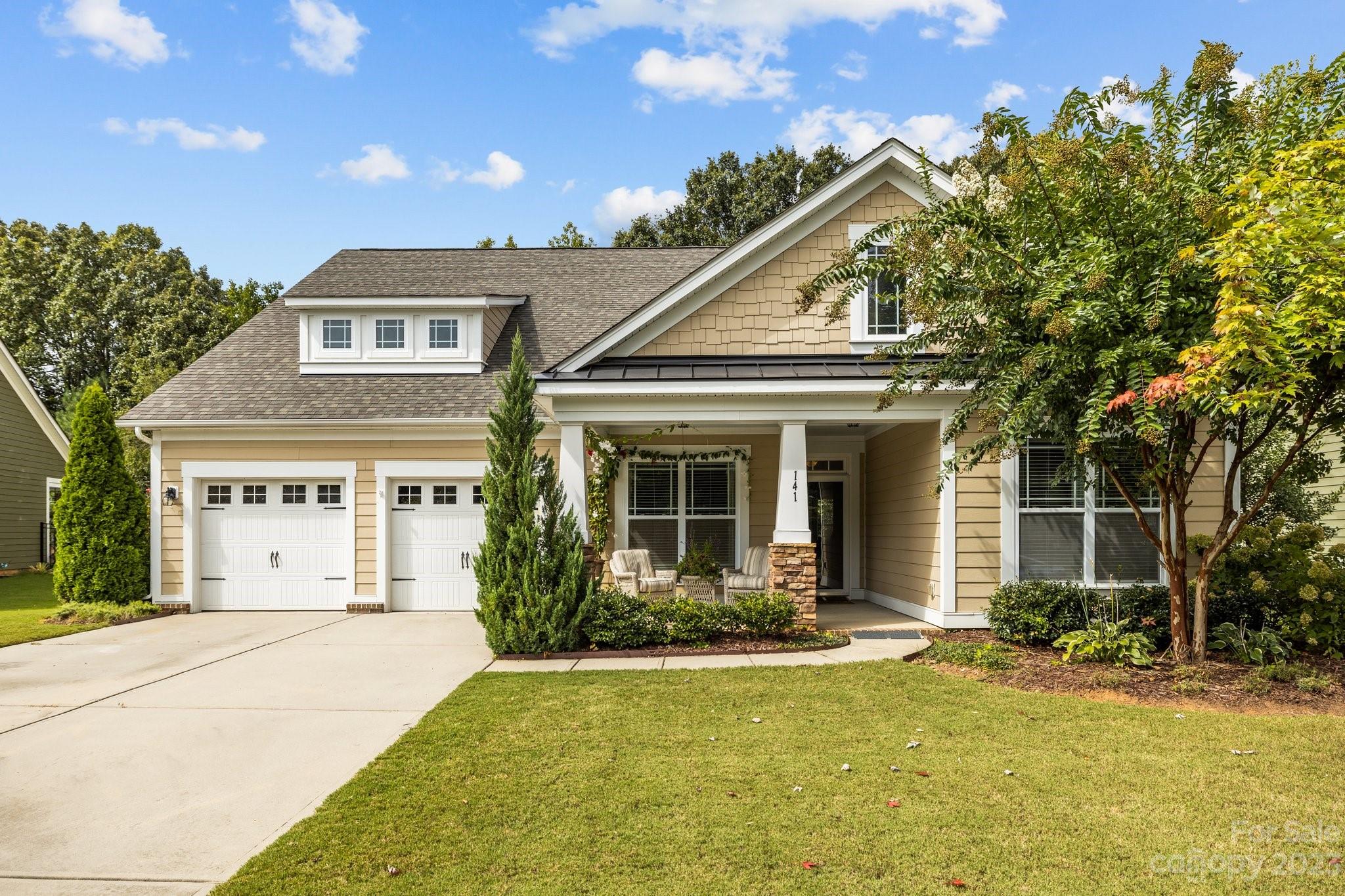 a front view of a house with garden