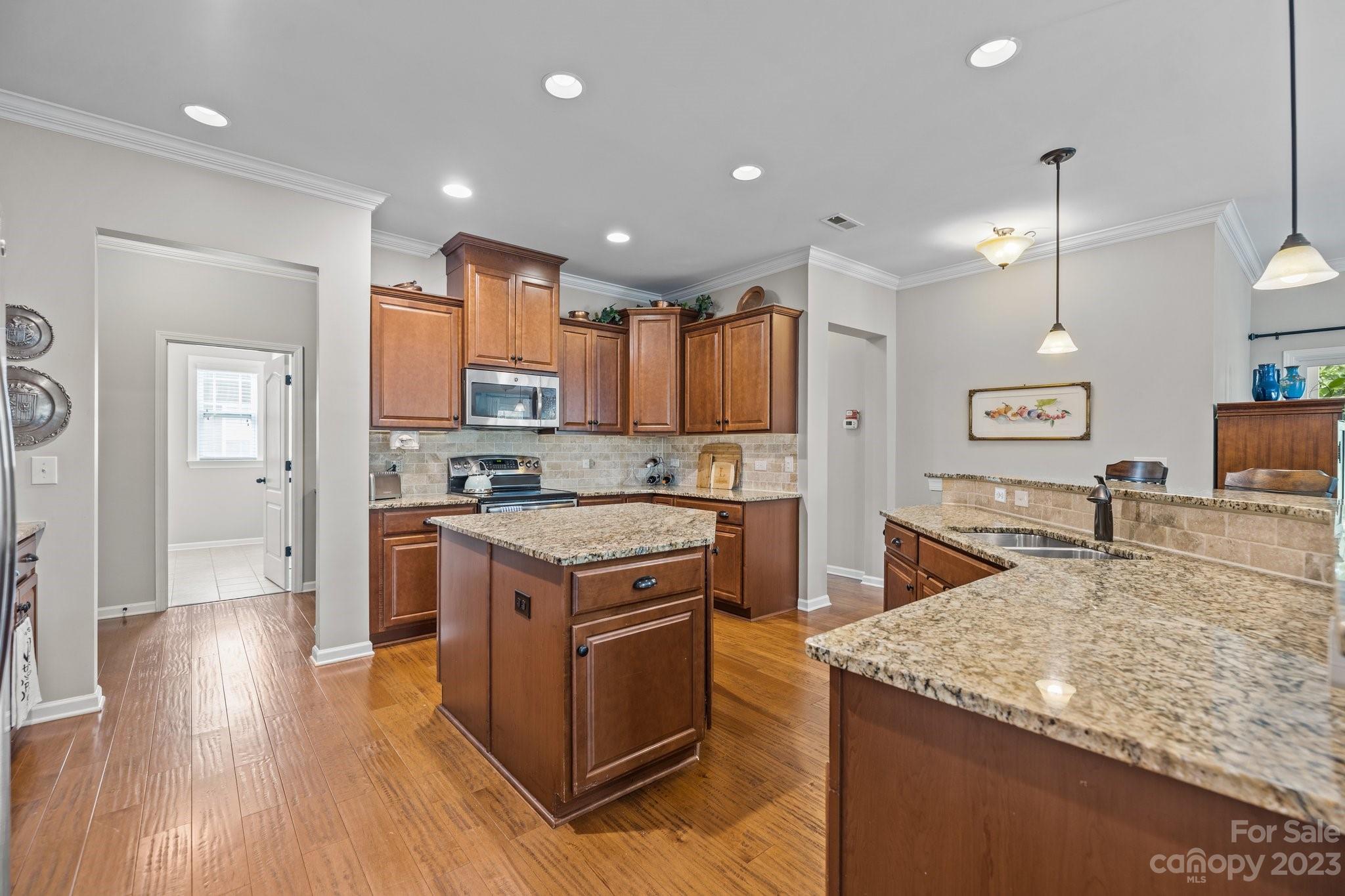 141 Hawks Creek Parkway Fort Mill, SC 29708 - Photo 11 of 44 a kitchen with stainless steel appliances granite countertop a sink a stove and a wooden floors