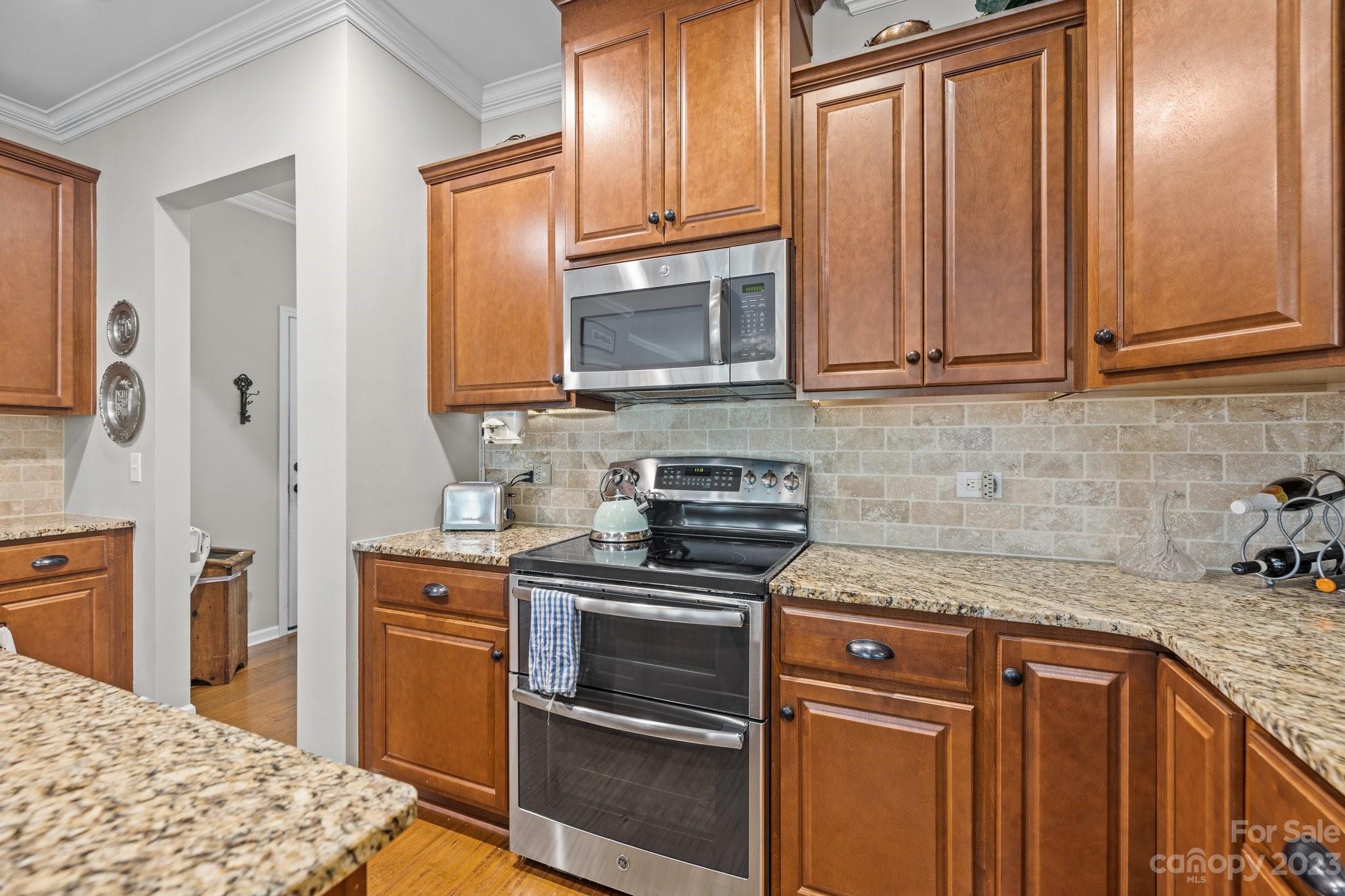 141 Hawks Creek Parkway Fort Mill, SC 29708 - Photo 13 of 44 a kitchen with stainless steel appliances granite countertop a stove a sink and a microwave