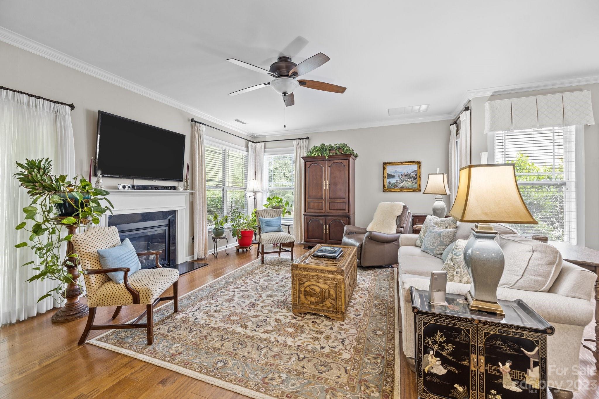 141 Hawks Creek Parkway Fort Mill, SC 29708 - Photo 15 of 44 a living room with furniture a flat screen tv and a fireplace