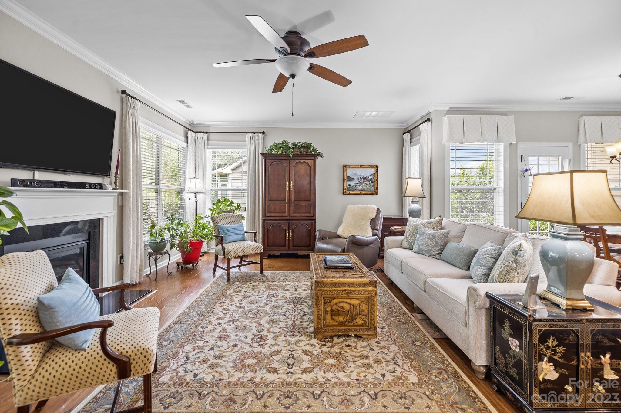 141 Hawks Creek Parkway Fort Mill, SC 29708 - Photo 17 of 44 a living room with furniture a flat screen tv and a fireplace