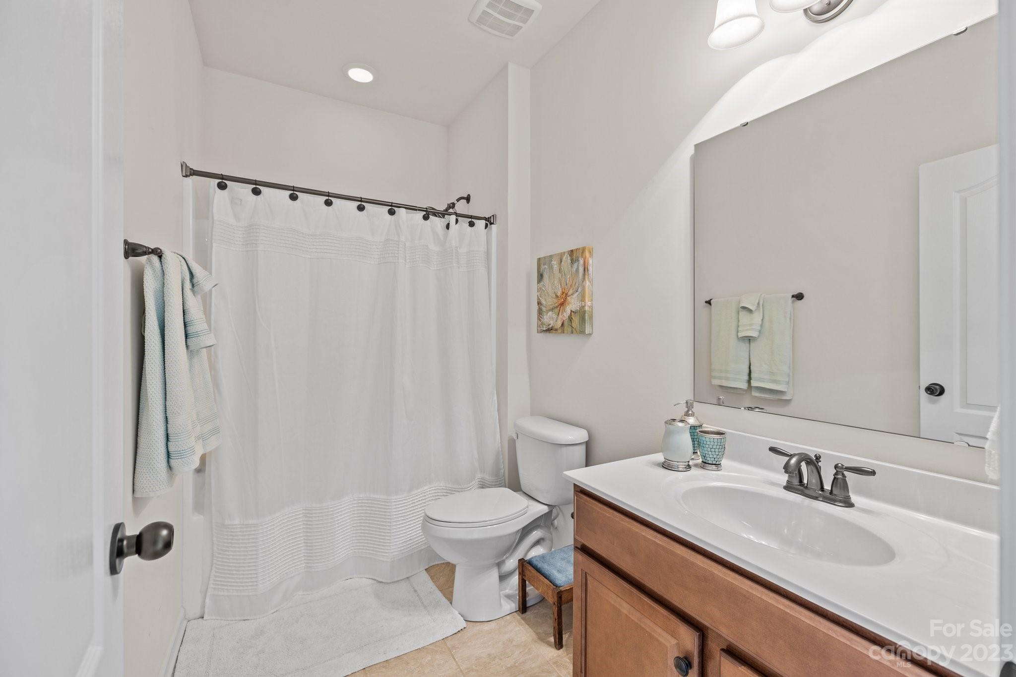 141 Hawks Creek Parkway Fort Mill, SC 29708 - Photo 27 of 44 a bathroom with a granite countertop sink toilet a mirror a vanity and shower
