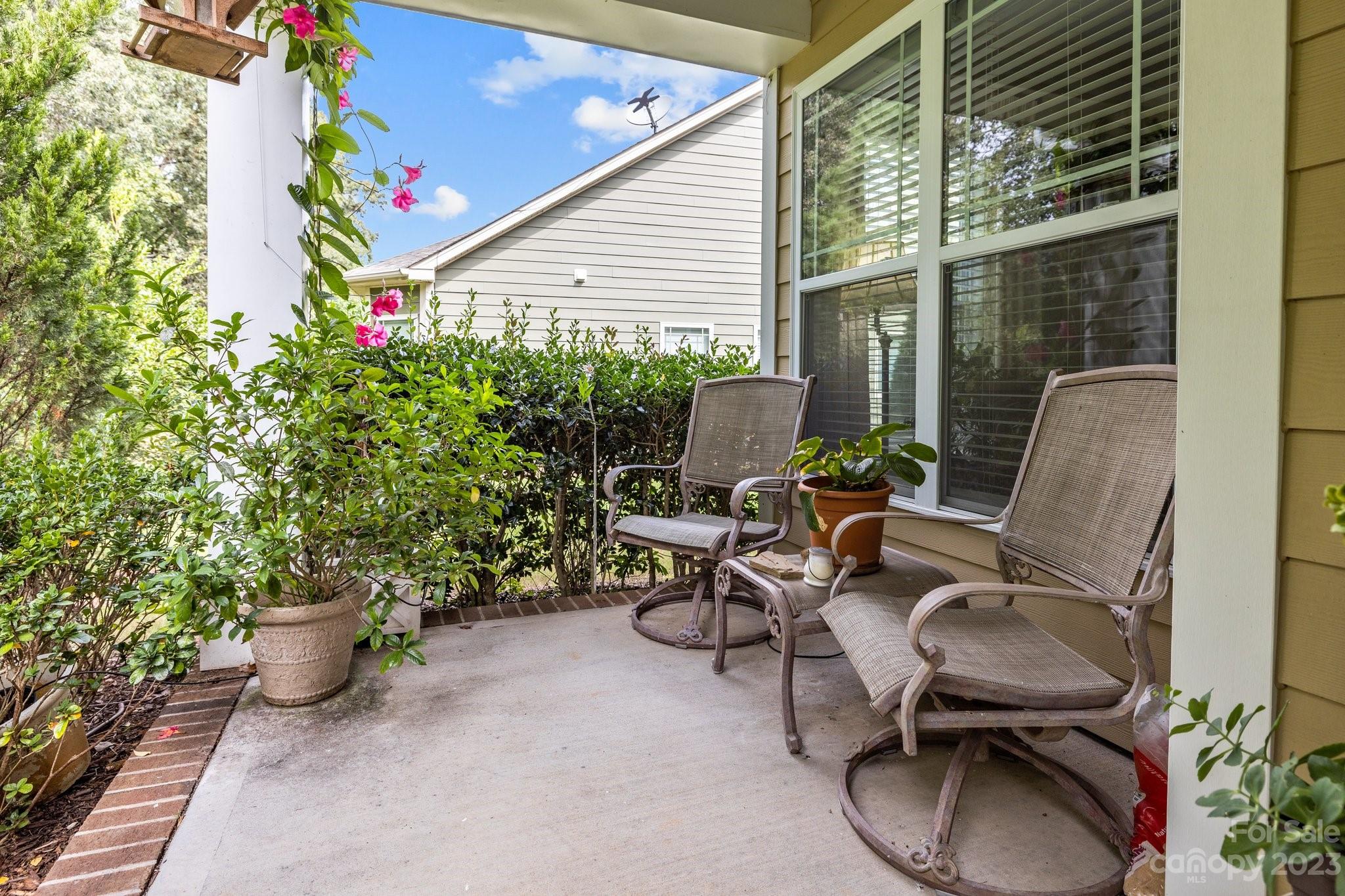 141 Hawks Creek Parkway Fort Mill, SC 29708 - Photo 35 of 44 a view of a chair and tables in the patio with potted plants