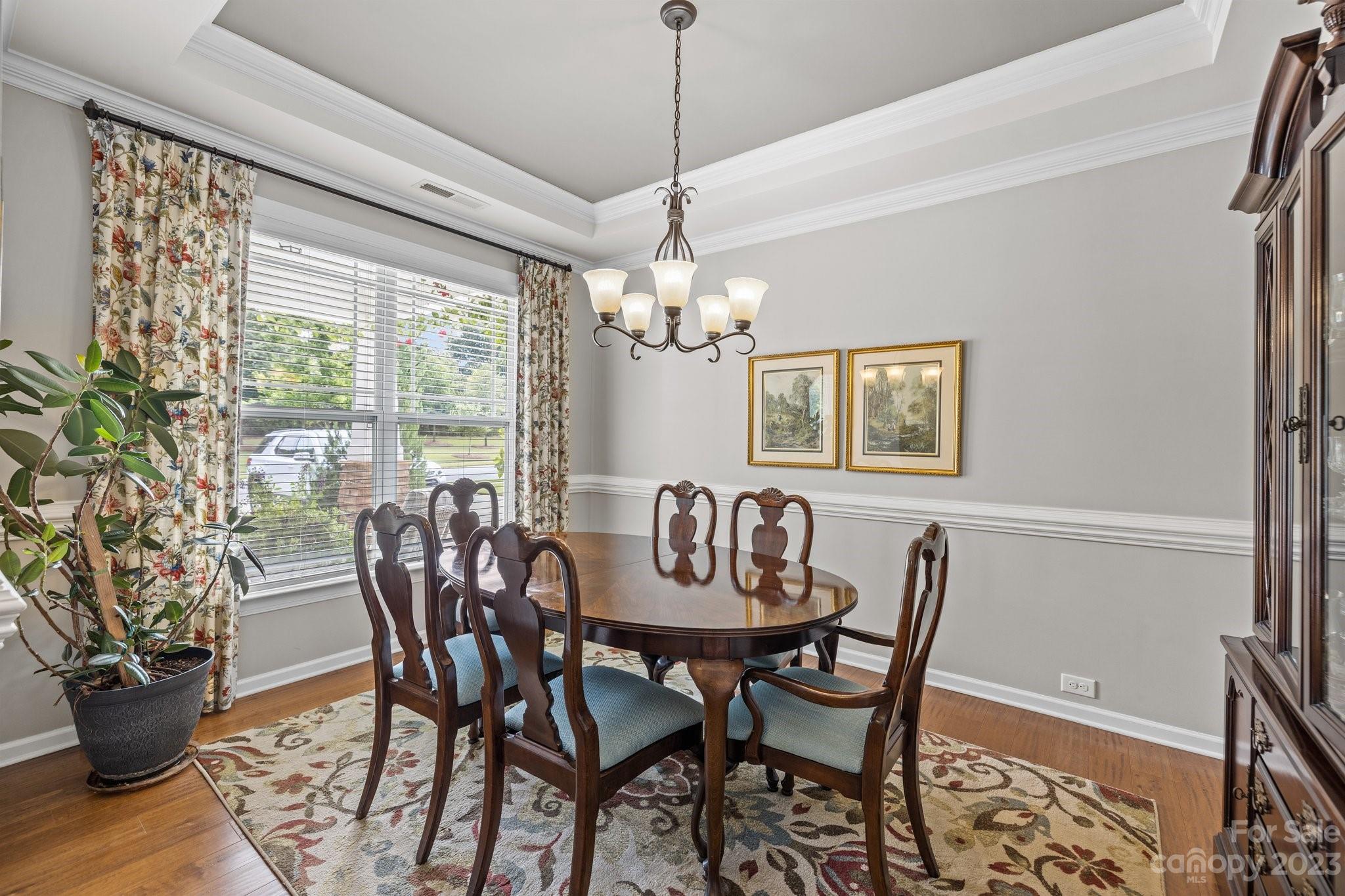 141 Hawks Creek Parkway Fort Mill, SC 29708 - Photo 4 of 44 a dining room with furniture potted plants and wooden floor