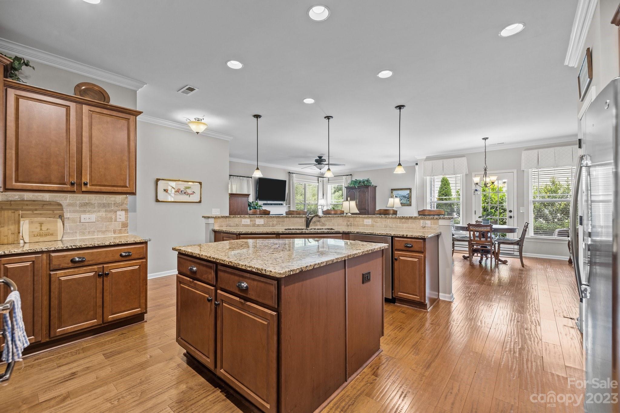 141 Hawks Creek Parkway Fort Mill, SC 29708 - Photo 10 of 44 a kitchen with a stove sink cabinets and wooden floor