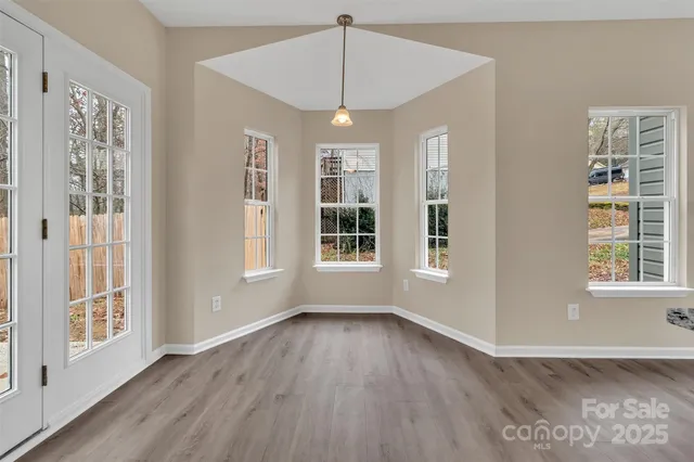 a view of livingroom with furniture wooden floor and windows
