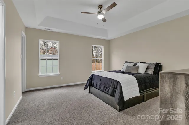 a spacious bedroom with a bed and window