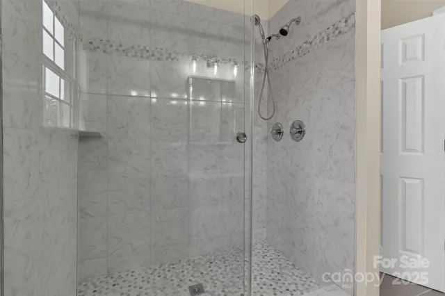 a bathroom with a glass shower door