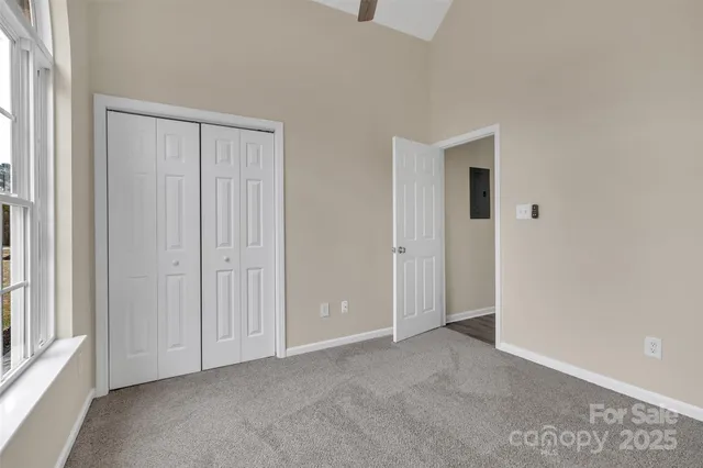 an empty room with windows and closet