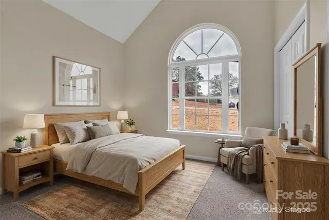 a bedroom with a bed and a large window