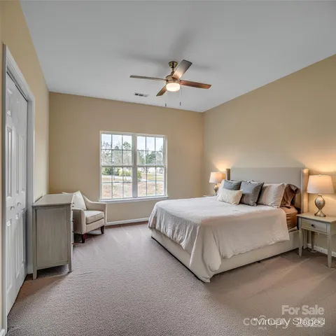 a bedroom with bed couch and window