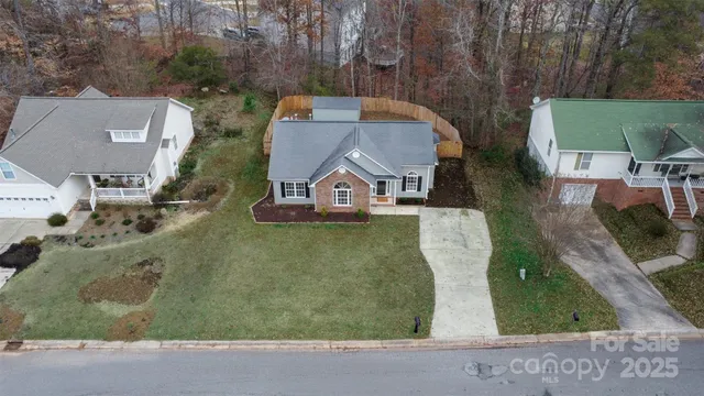an aerial view of a house with garden space and street view