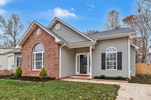a front view of a house with a yard and outdoor seating