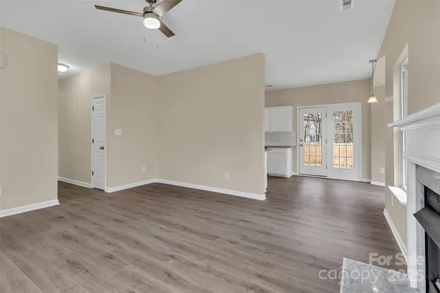 wooden floor in an empty room with a fireplace