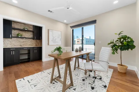 a living room with furniture and a potted plant