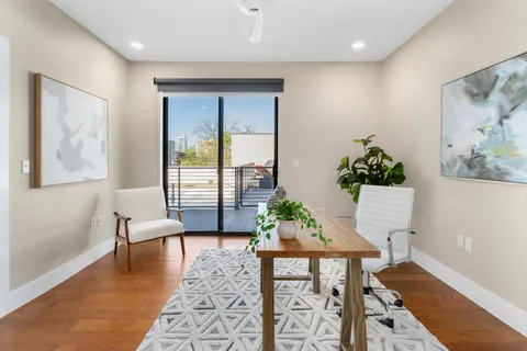 a living room with furniture and wooden floor