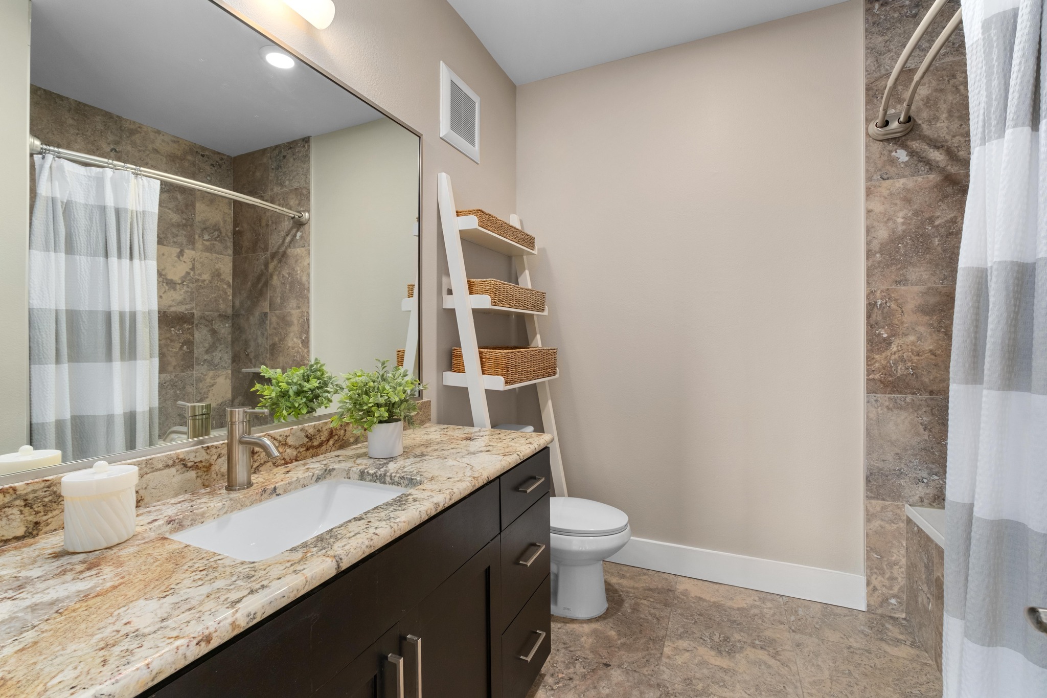 1615 East 7th Street, Unit 402 Austin, TX 78702 - Photo 16 of 23 a bathroom with a granite countertop sink and a mirror