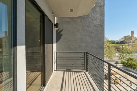 a view of balcony with wooden floor