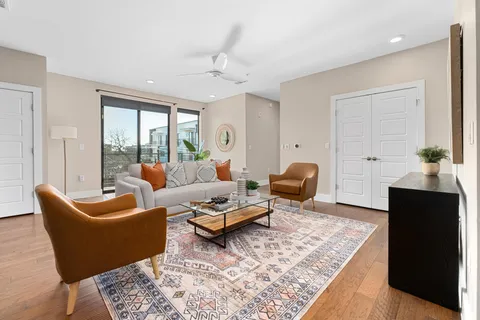 a living room with furniture rug and window