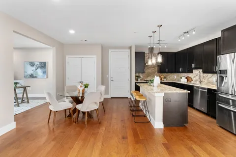 a living room with furniture and kitchen view