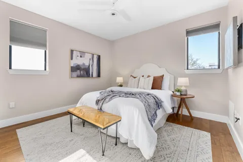 a bedroom with a bed and a painting on the wall