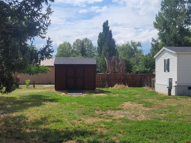 a view of a house with backyard and couches