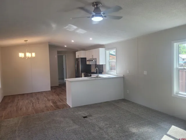 a view of a kitchen and window in a room