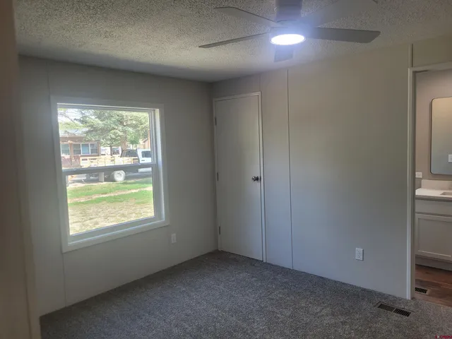 an empty room with wooden floor and a window