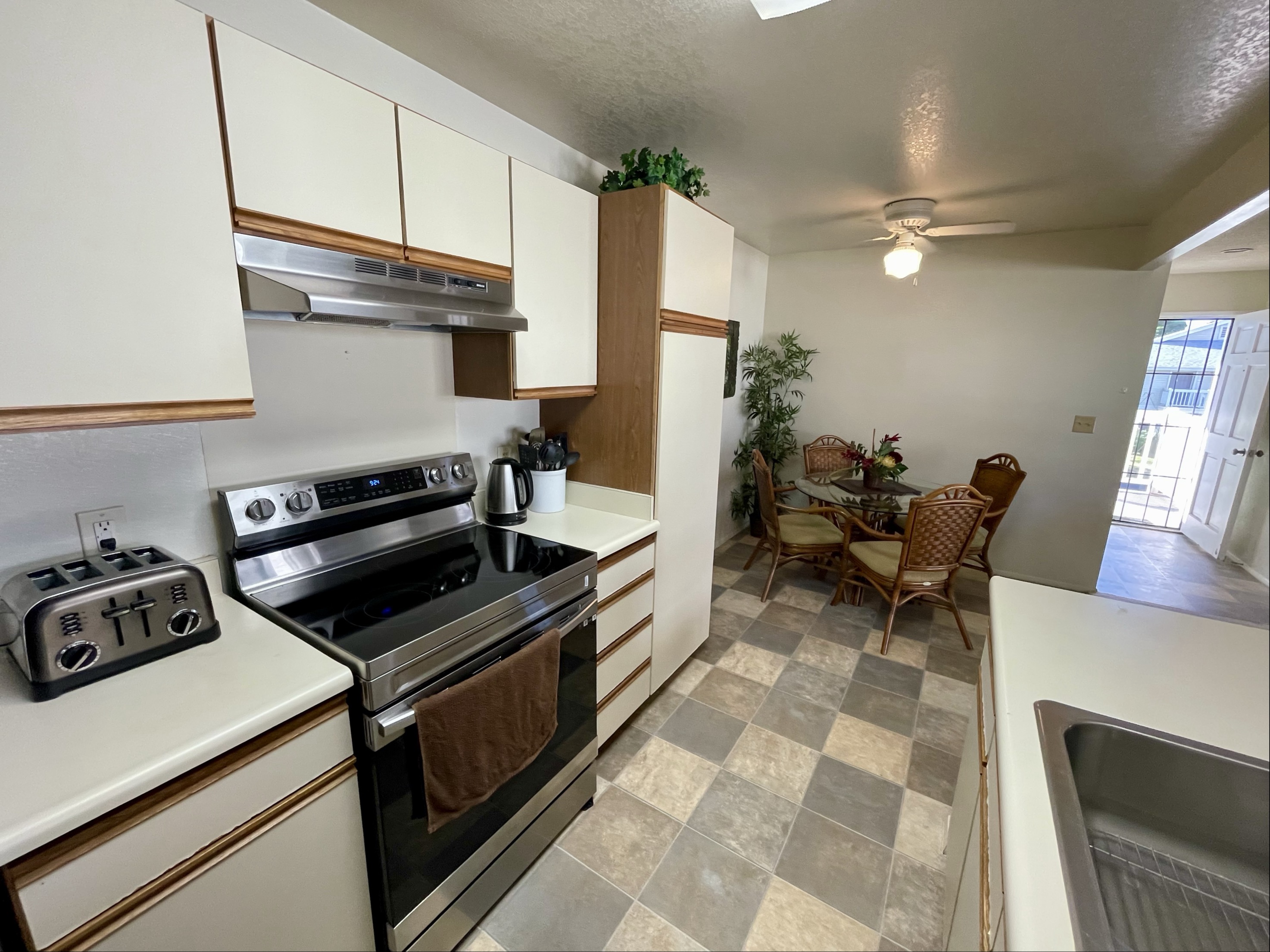 68-3883 Lua Kula Street, Unit 2005 Waikoloa, HI 96738 - Photo 12 of 28 a kitchen with a sink cabinets and appliances