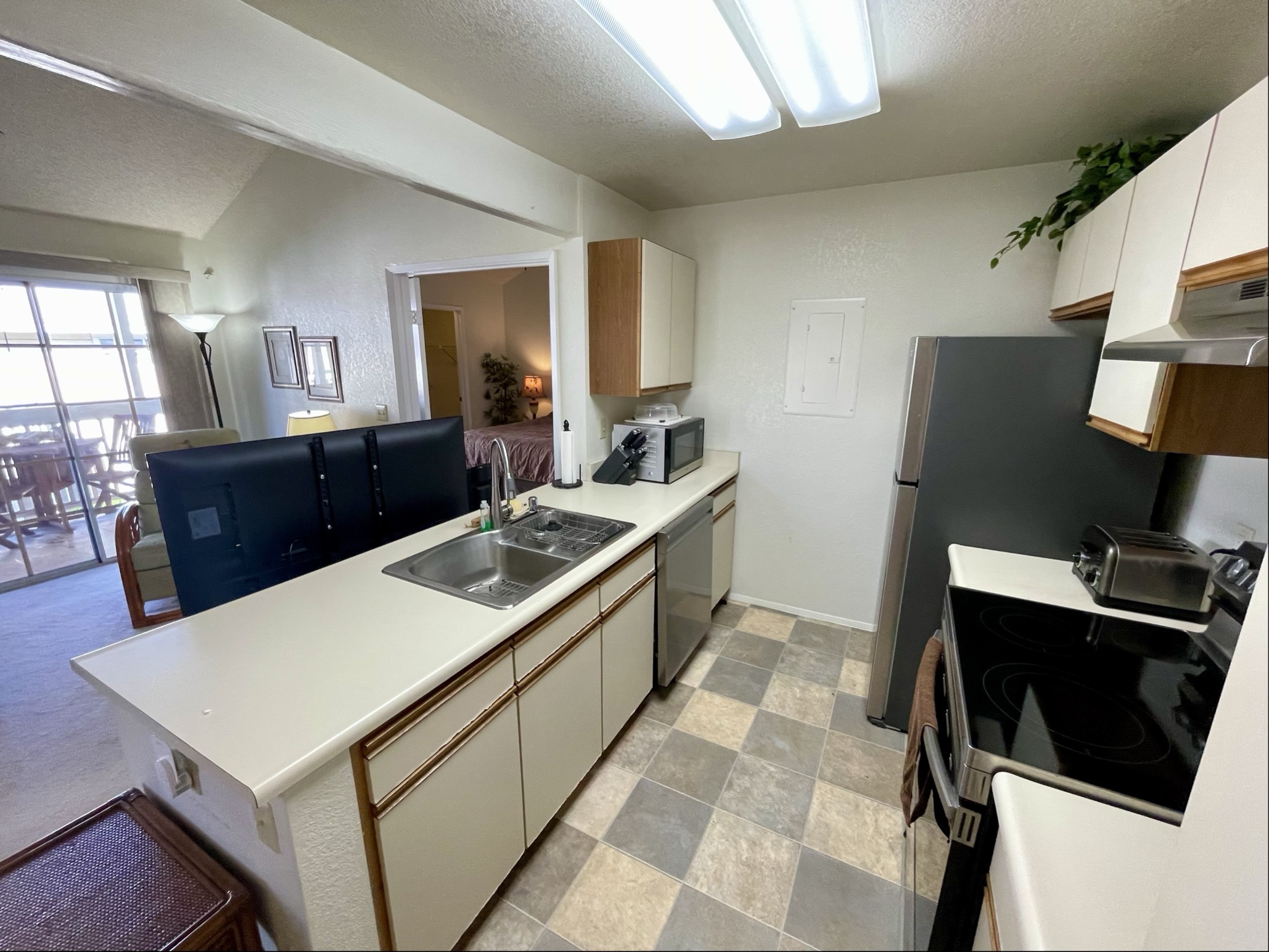 68-3883 Lua Kula Street, Unit 2005 Waikoloa, HI 96738 - Photo 14 of 28 a kitchen with a stove a sink and a refrigerator